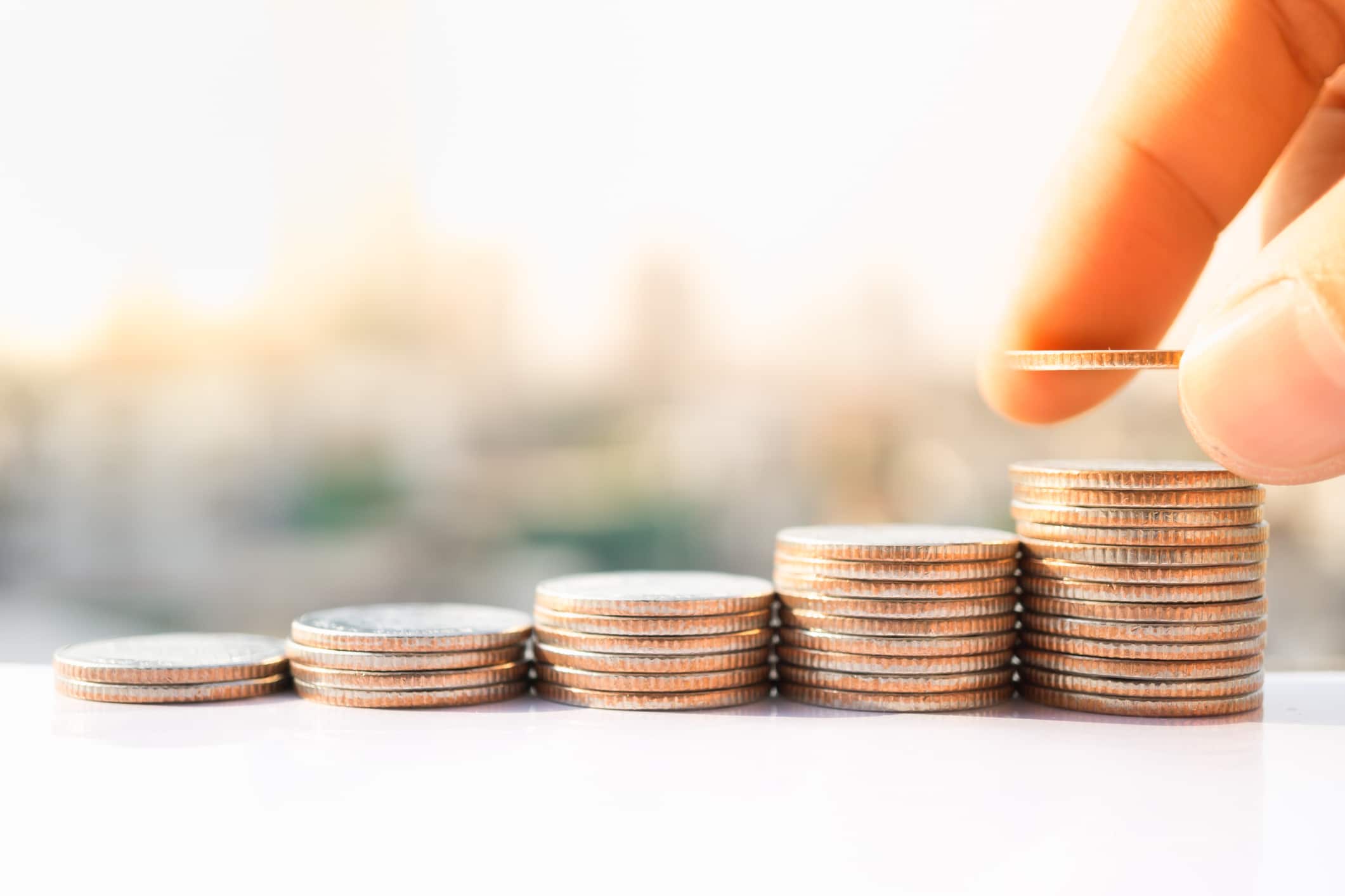 hand stacking up coins
